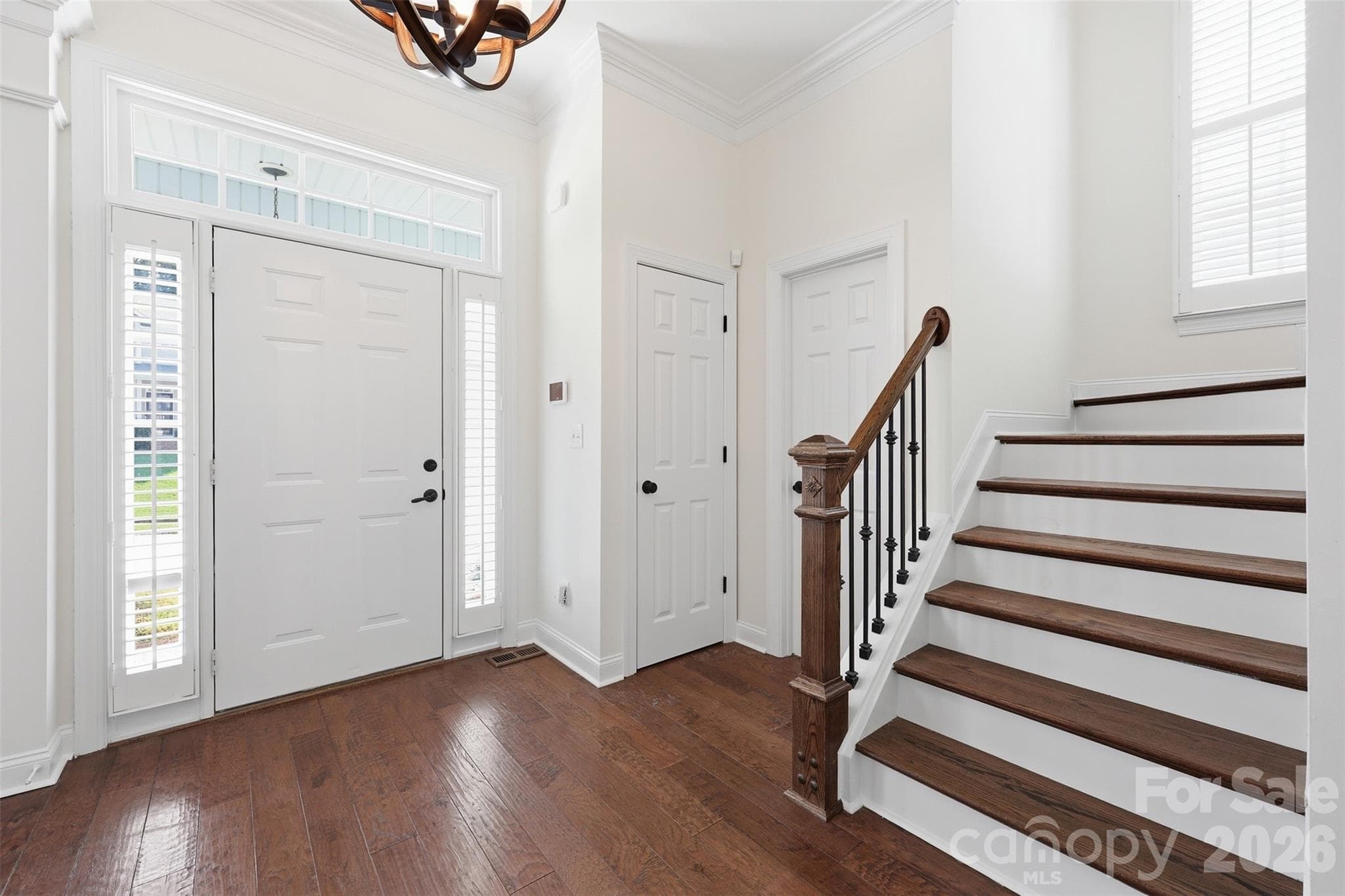 Stunning staircase featuring wood treads and elegant iron spindles! - 6832 Charter Hills Road, Charlotte