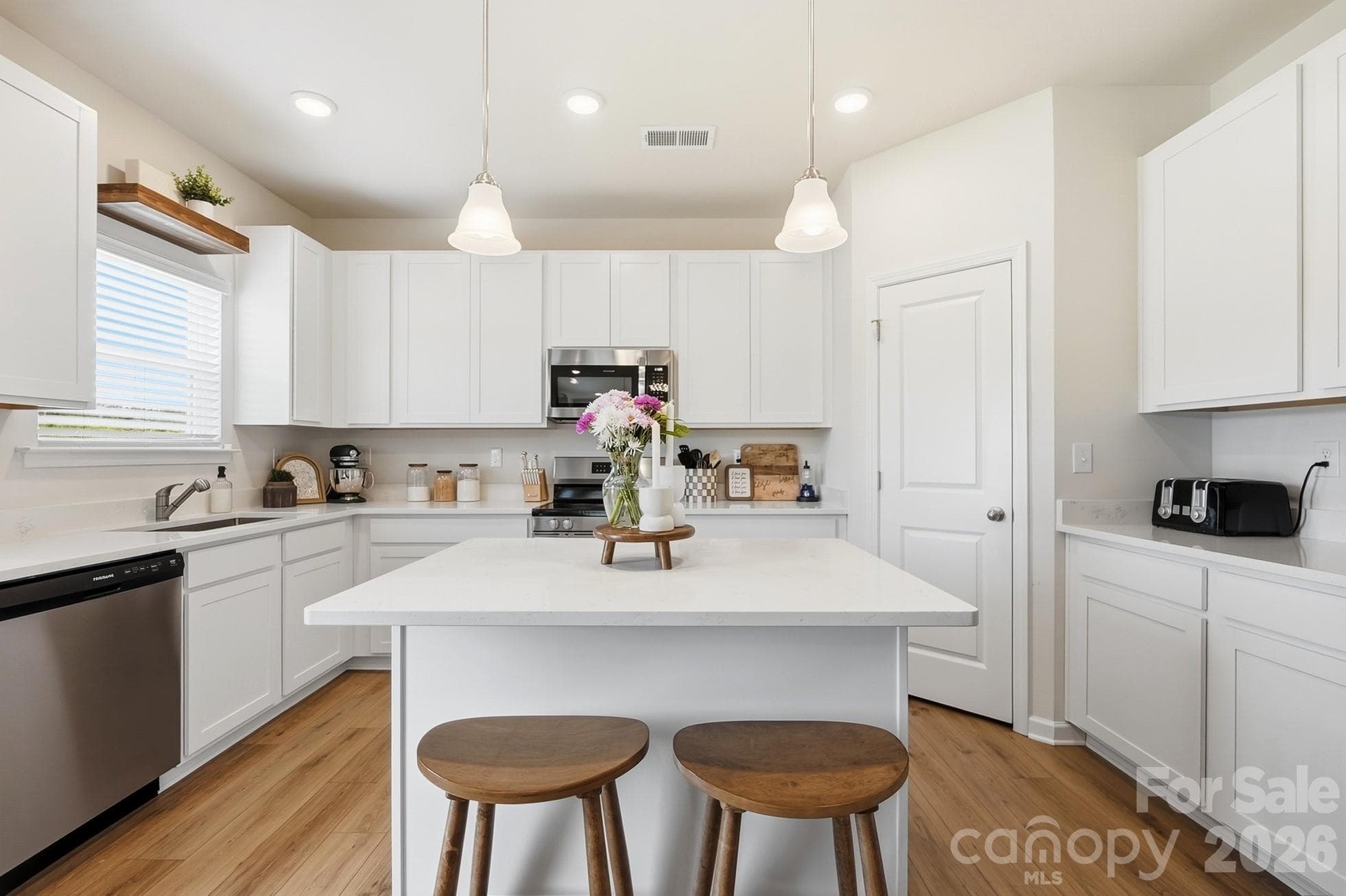 Kitchen island provides additional prep space and casual seating. - 6023 Busch Way, Midland