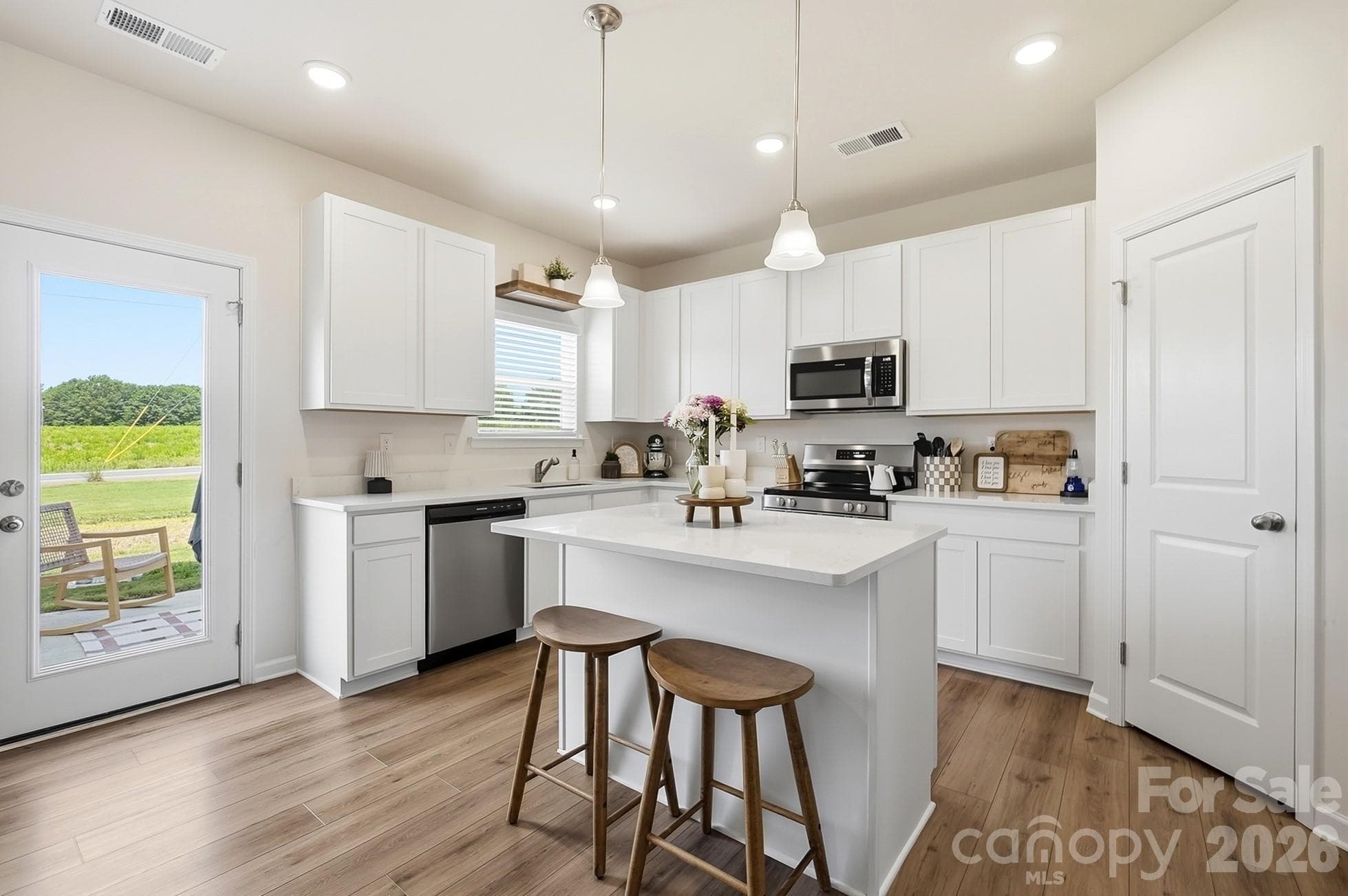 Bright kitchen with pantry storage and backyard views. - 6023 Busch Way, Midland