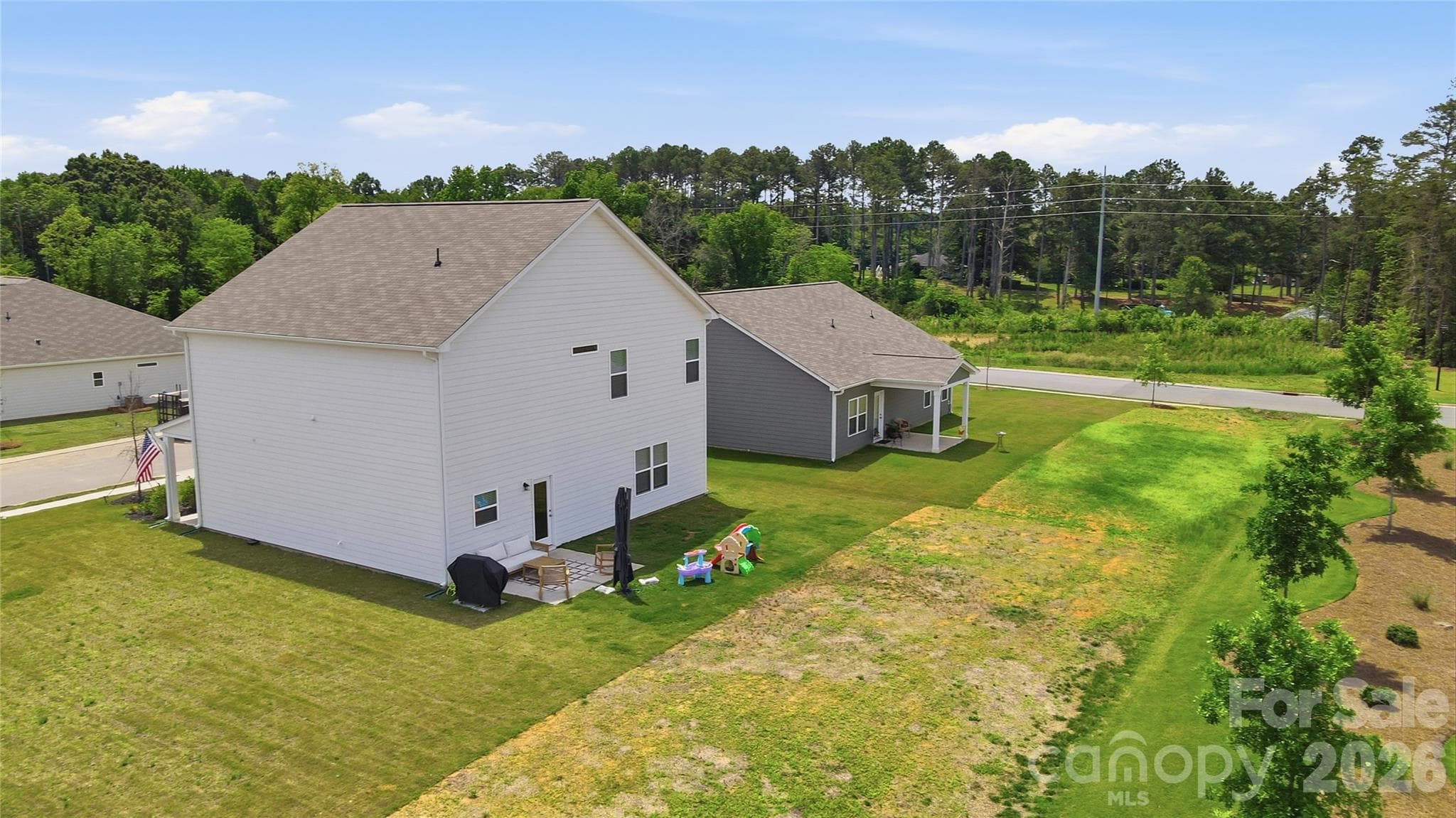 Aerial view of the backyard and neighboring green space. - 6023 Busch Way, Midland