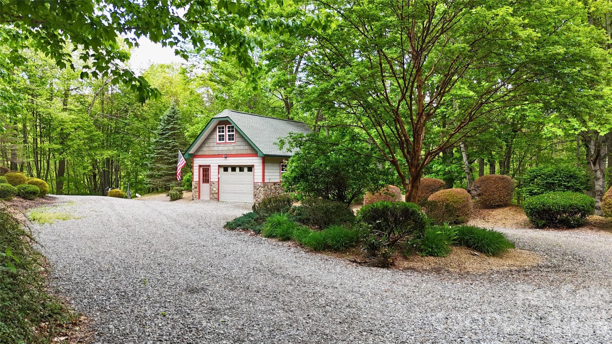 Ample parking in the circular driveway, with the detached garage shown at the end. - Waynesville