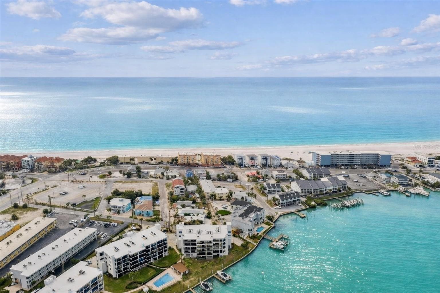 BEST LOCATION ON TREASURE ISLAND! Between the Gulf of Mexico and Blind Pass Waterway, Unit 404 offers the perfect blend of waterfront living and beachside convenience. - 9825 HARRELL AVE #404, TREASURE ISLAND