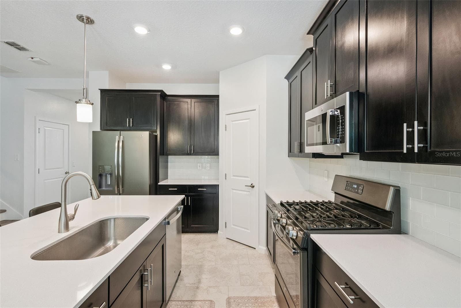 Stainless steel appliances and generous cabinet storage - 1235 DORA PARC LN, MOUNT DORA
