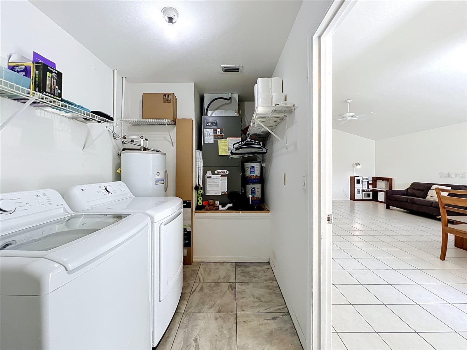 Enter this home through the garage, which leads directly into a convenient laundry and utility room. - 554 WHITTINGHAM PL, LAKE MARY