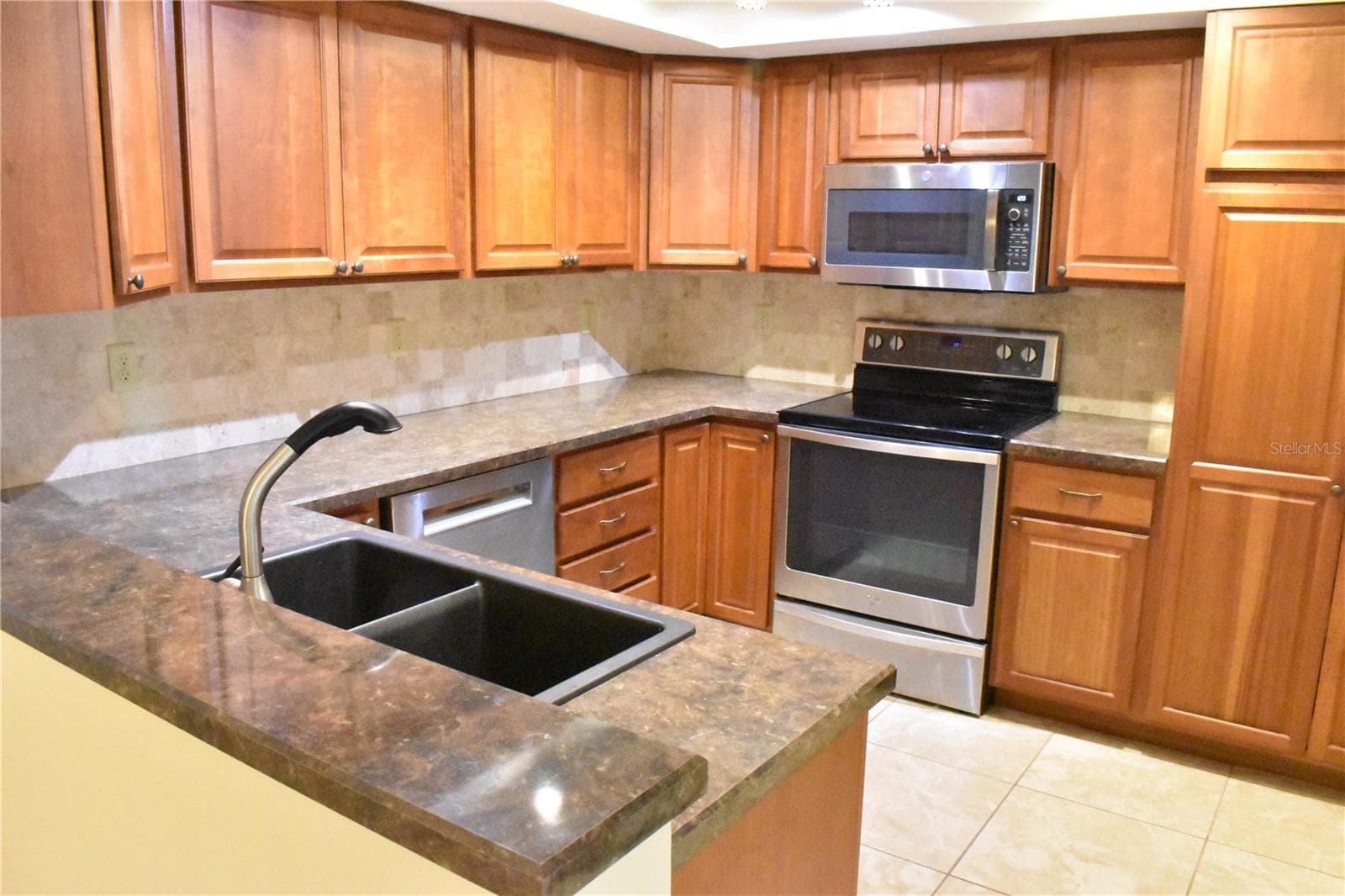 Kitchen with Stainless Appliances nice wood cabinets - 7606 15TH AVE NW, BRADENTON