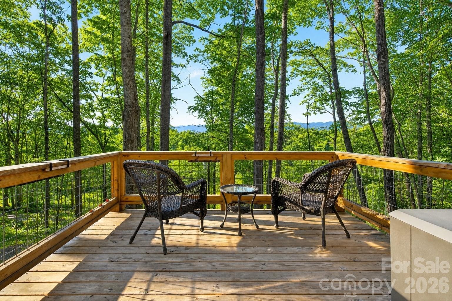 Morning coffee never tasted better than here. Private deck off primary bedroom on the main floor. - 1413 Golf Course Road, Old Fort
