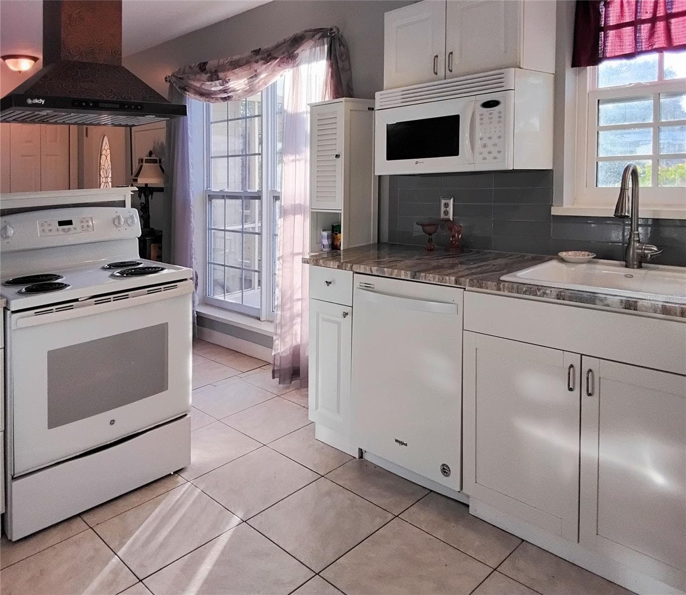 Kitchen with lots of natural light and granite countertops - 2440 ELKCAM BLVD, PORT CHARLOTTE