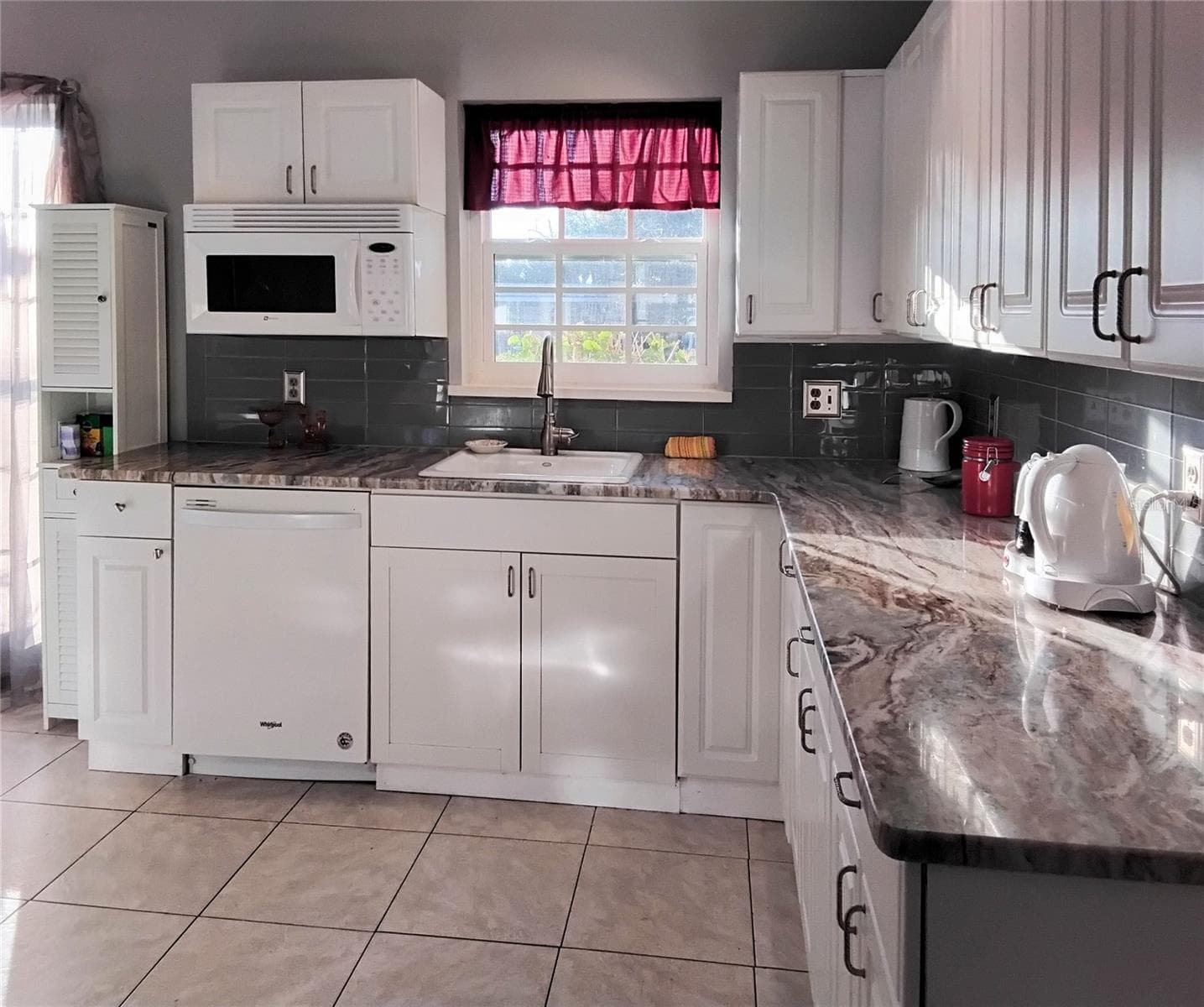Kitchen looking to window in front of home - 2440 ELKCAM BLVD, PORT CHARLOTTE