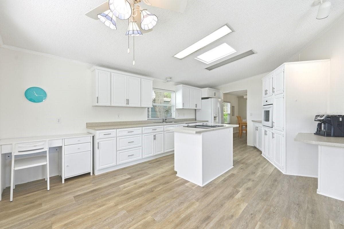 Current owner also has a desk in this spacious kitchen. This view is taken from the dinette area. - 304 PORTSIDE LN, EDGEWATER