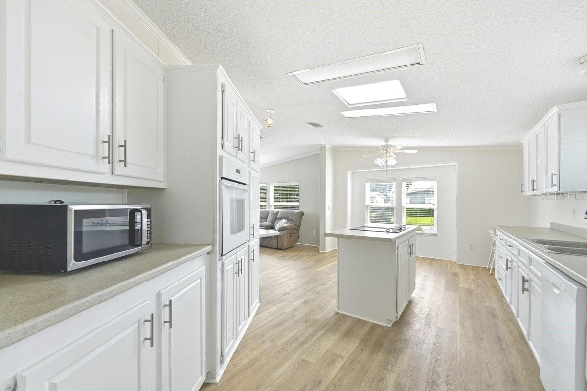 So many cabinets. Two windowsi in the background is eat in kitchen for your table. - 304 PORTSIDE LN, EDGEWATER
