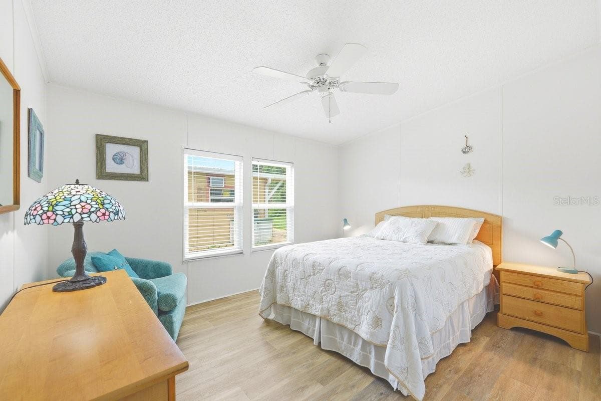 Bedroom 1 with Vinyl luxury Flooring, ceiling fan, and large closet - 304 PORTSIDE LN, EDGEWATER