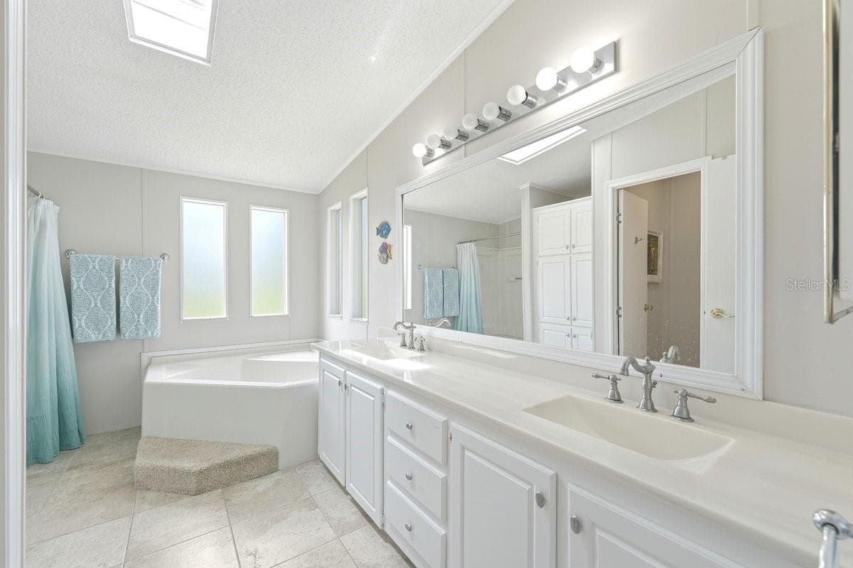 Owner's Bathroom with Dual Built in Sinks and Nickel Finishes. - 304 PORTSIDE LN, EDGEWATER