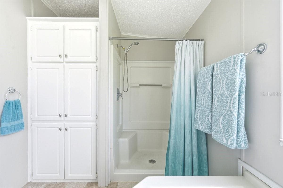 View from Tub showing Shower with seating and Linen closet - 304 PORTSIDE LN, EDGEWATER