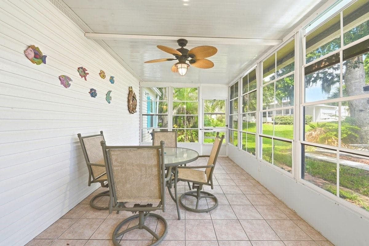 Two Doors leading outside either to front of house or to back of home. This view is showing back of home. Lots of Natural Light on this great Florida Room - 304 PORTSIDE LN, EDGEWATER