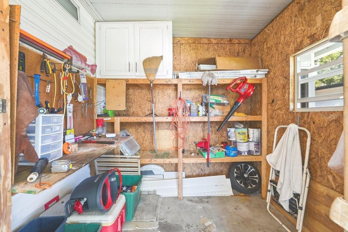 Carport Storage Room; perfect for tools and hobbies. - 304 PORTSIDE LN, EDGEWATER