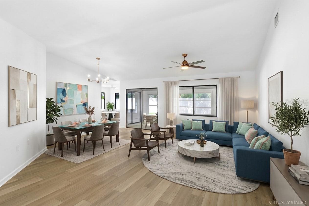 Virtually Staged: From Foyer to Living/Dining Room. Enclosed Patio and Outdoor terrace beyond the glass doors.  Dinette and Kitchen to the left and two bedrooms with connected bathrooms to the right. - 4949 PLEASANT HOLLOW TRL #211, LAKELAND