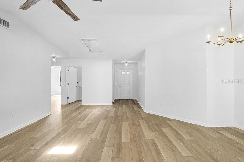 Entrances to Hall bath and Second Bedroom top Left.  Behind the pictured Living and Dining Rooms, is the Sliding glass door and Rear Enclosed patio. - 4949 PLEASANT HOLLOW TRL #211, LAKELAND