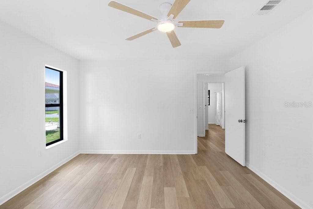 Primary Bedroom, to the rear is the ensuite . Through the door is the hall to the second bedroom and bath. To the right is the Foyer and Living/Dining Area. - 4949 PLEASANT HOLLOW TRL #211, LAKELAND