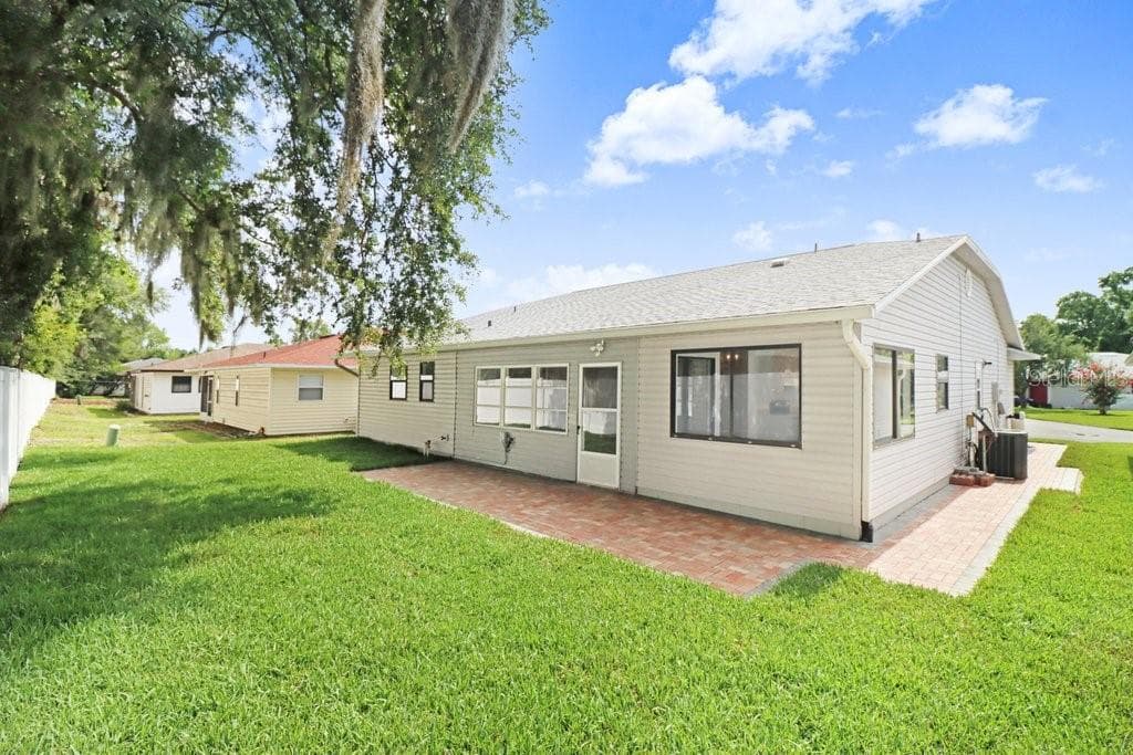 Back Yard with paver terrace and entrance to enclosed porch - 4949 PLEASANT HOLLOW TRL #211, LAKELAND