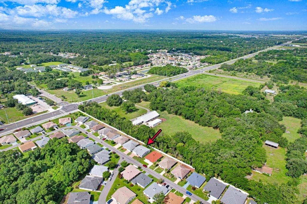 4949 Pleasant Hollow Trail with rear community fence and nearby trees providing shade and beauty. - 4949 PLEASANT HOLLOW TRL #211, LAKELAND