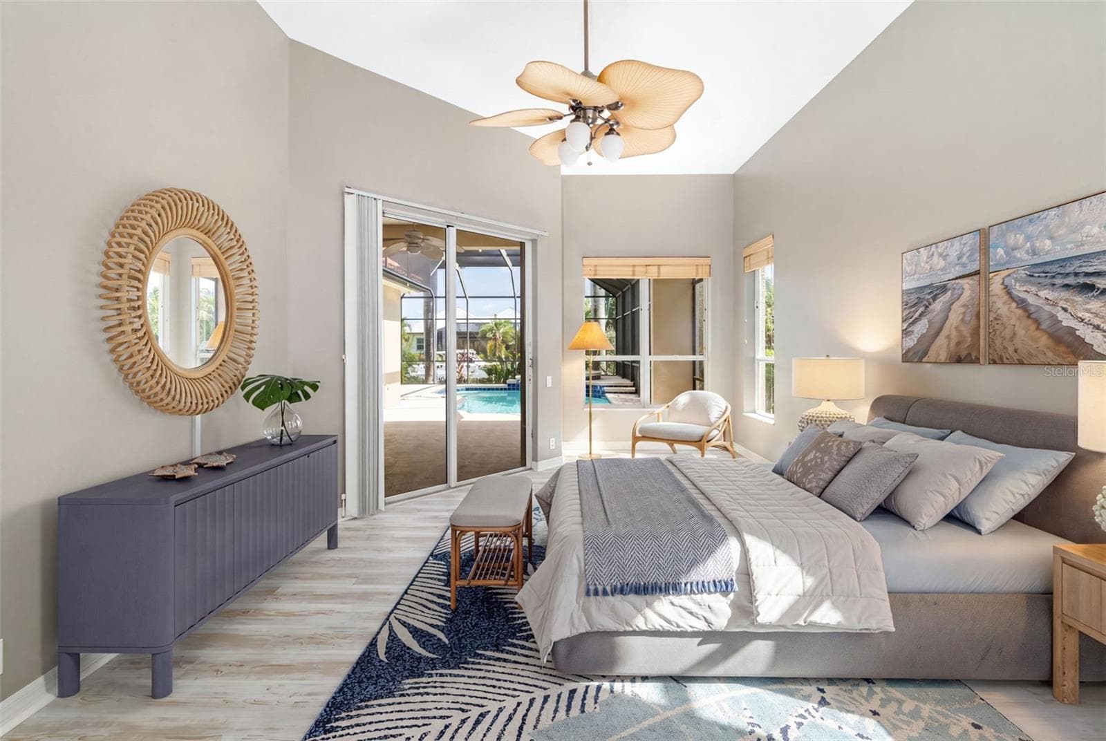 Primary, bedroom, sitting area, private access to lanai with water view overlooking the pool/spa. - 4770 MAINSAIL DR, BRADENTON