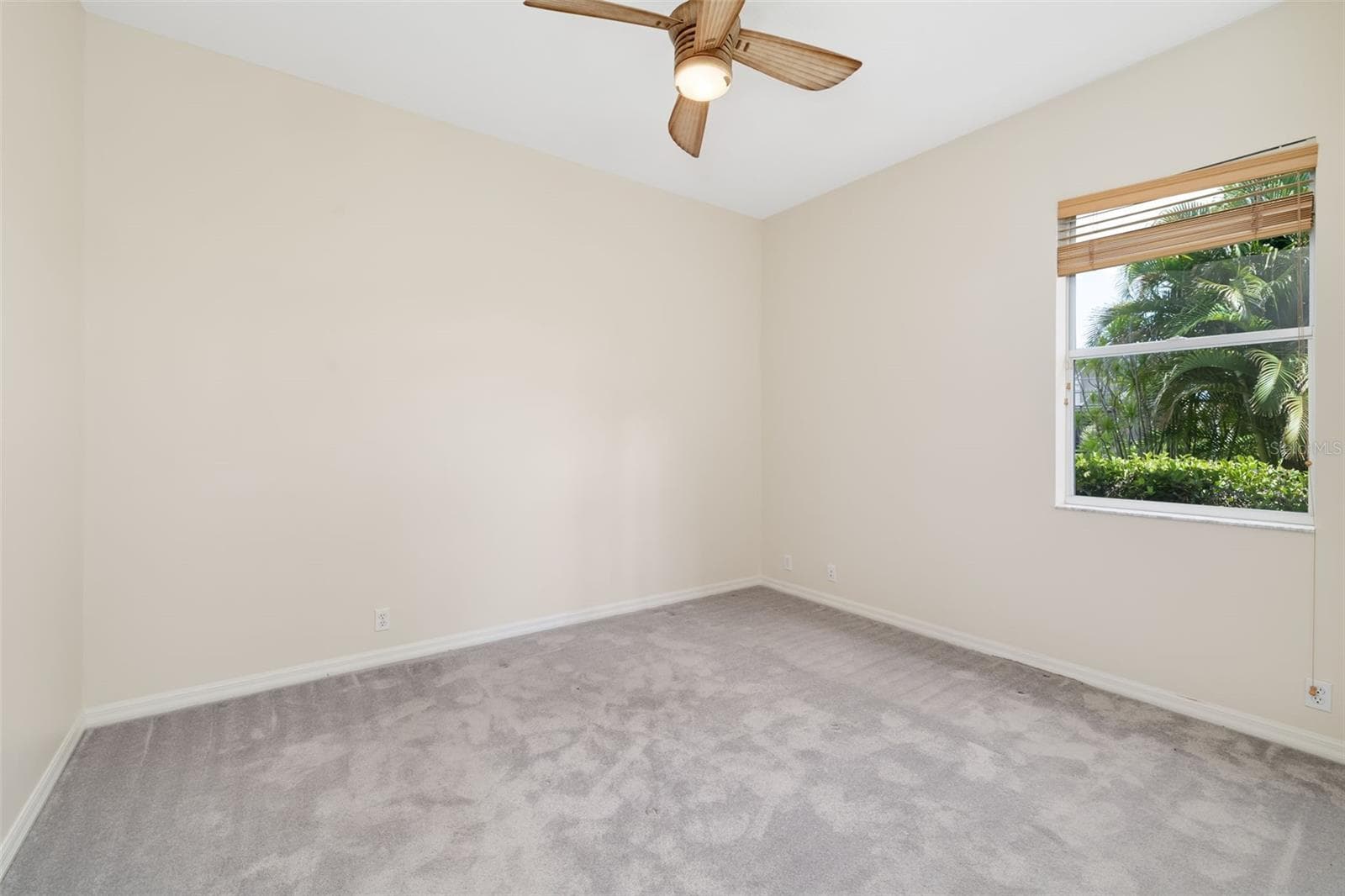 Bedroom 3 with large closet and view of the backyard and boat dock - 4770 MAINSAIL DR, BRADENTON