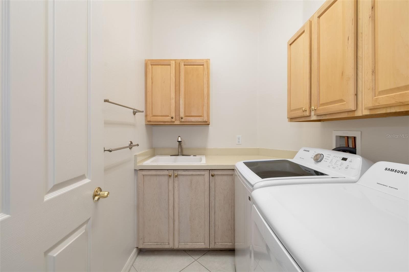 Interior laundry room, utility sink and storage cabinets, washer and dryer - 4770 MAINSAIL DR, BRADENTON