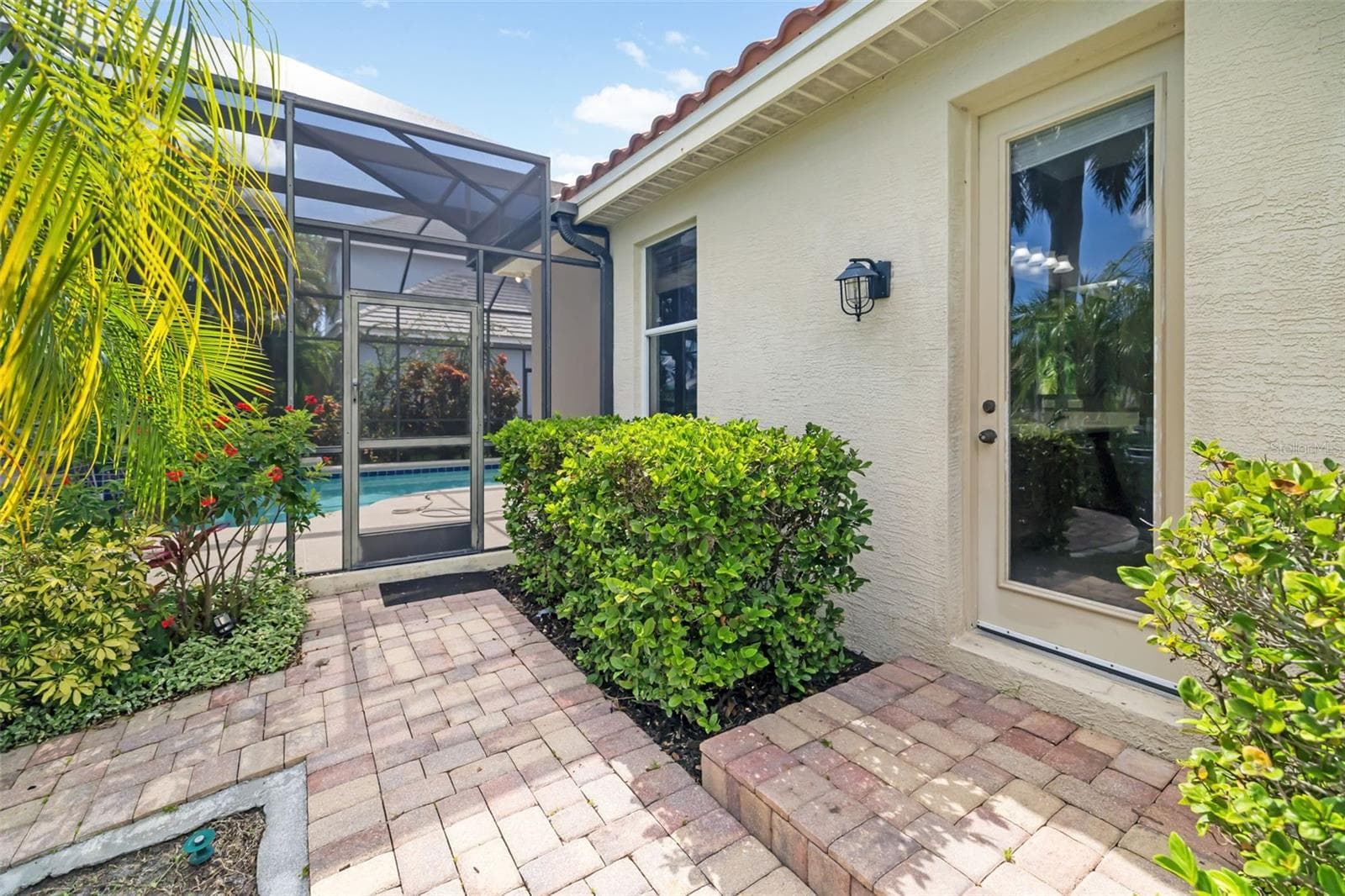 Bathroom two door leading out to the backyard, pool, lanai, boat dock and Freshwater canal - 4770 MAINSAIL DR, BRADENTON