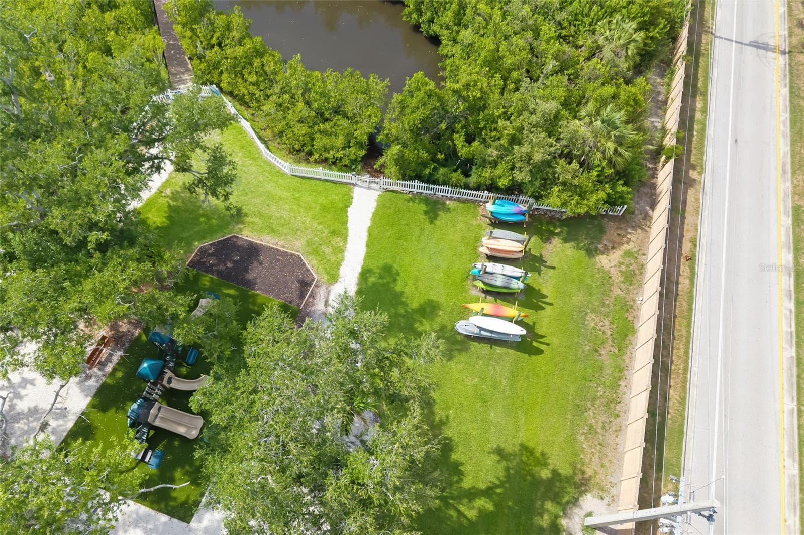 Enjoy nature with mature, lush tropical Palms, community kayak launch, walking bridge that winds around the community at Harbour Walk - 4770 MAINSAIL DR, BRADENTON