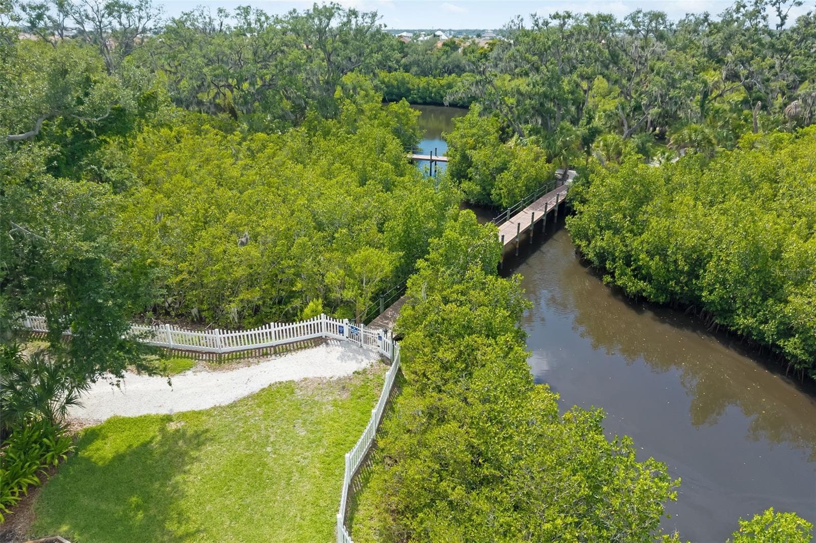 Community fishing dock, bridge with walking, hiking trails winding throughout the community - 4770 MAINSAIL DR, BRADENTON
