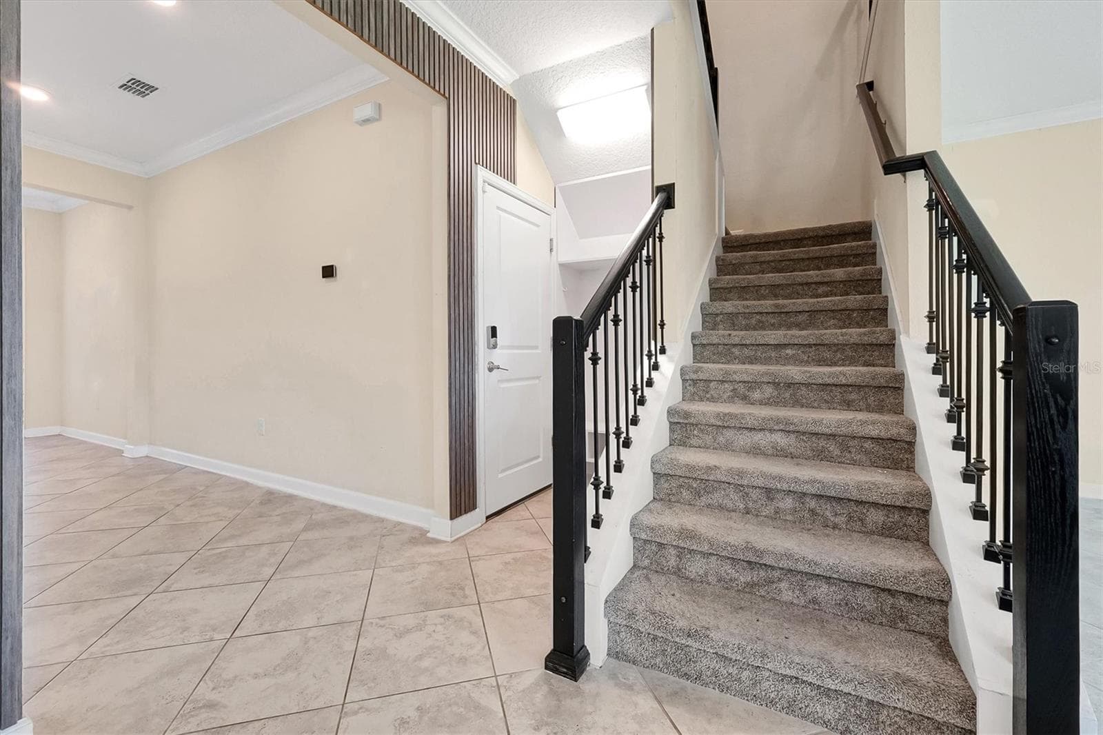 Garage door entrance/drop zone area/stairs to upstairs living - 12151 IMAGINARY WAY, ORLANDO