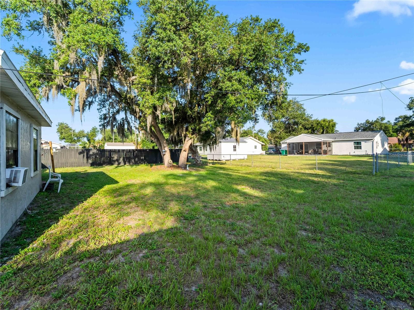 Backyard_1018RedBayTer_PortCharlotte_MatureTrees_Daylight.jpg - 1018 RED BAY TER NW, PORT CHARLOTTE