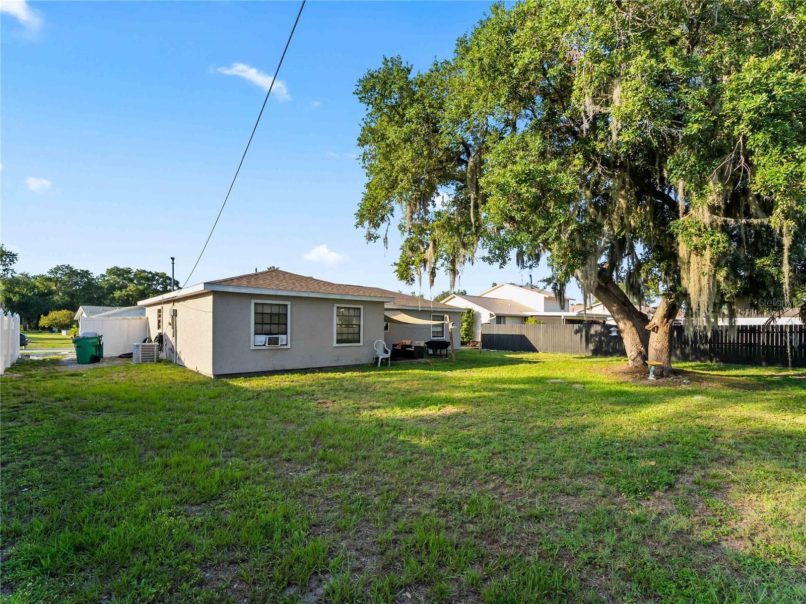 RearExterior_1018RedBayTer_PortCharlotte_FencedBackyard_Daylight.jpg - 1018 RED BAY TER NW, PORT CHARLOTTE