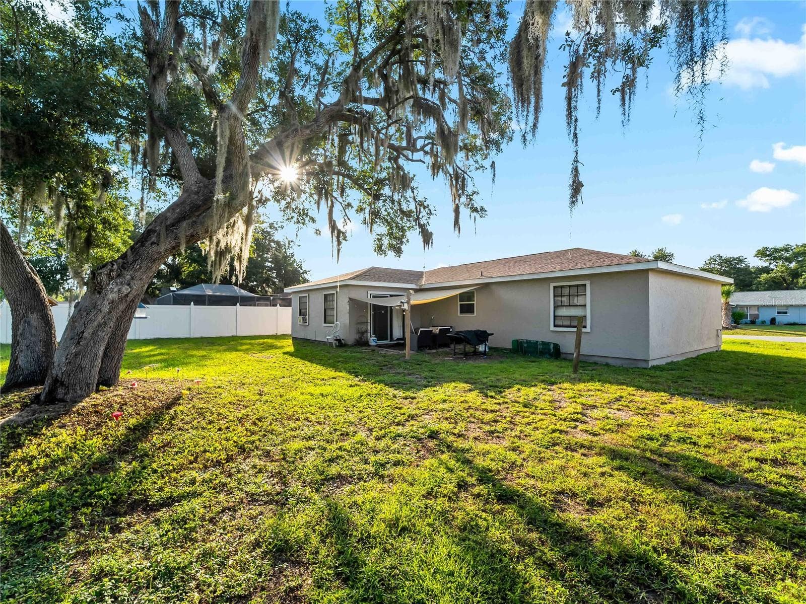 RearExterior_1018RedBayTer_PortCharlotte_MatureTrees_Daylight.jpg - 1018 RED BAY TER NW, PORT CHARLOTTE