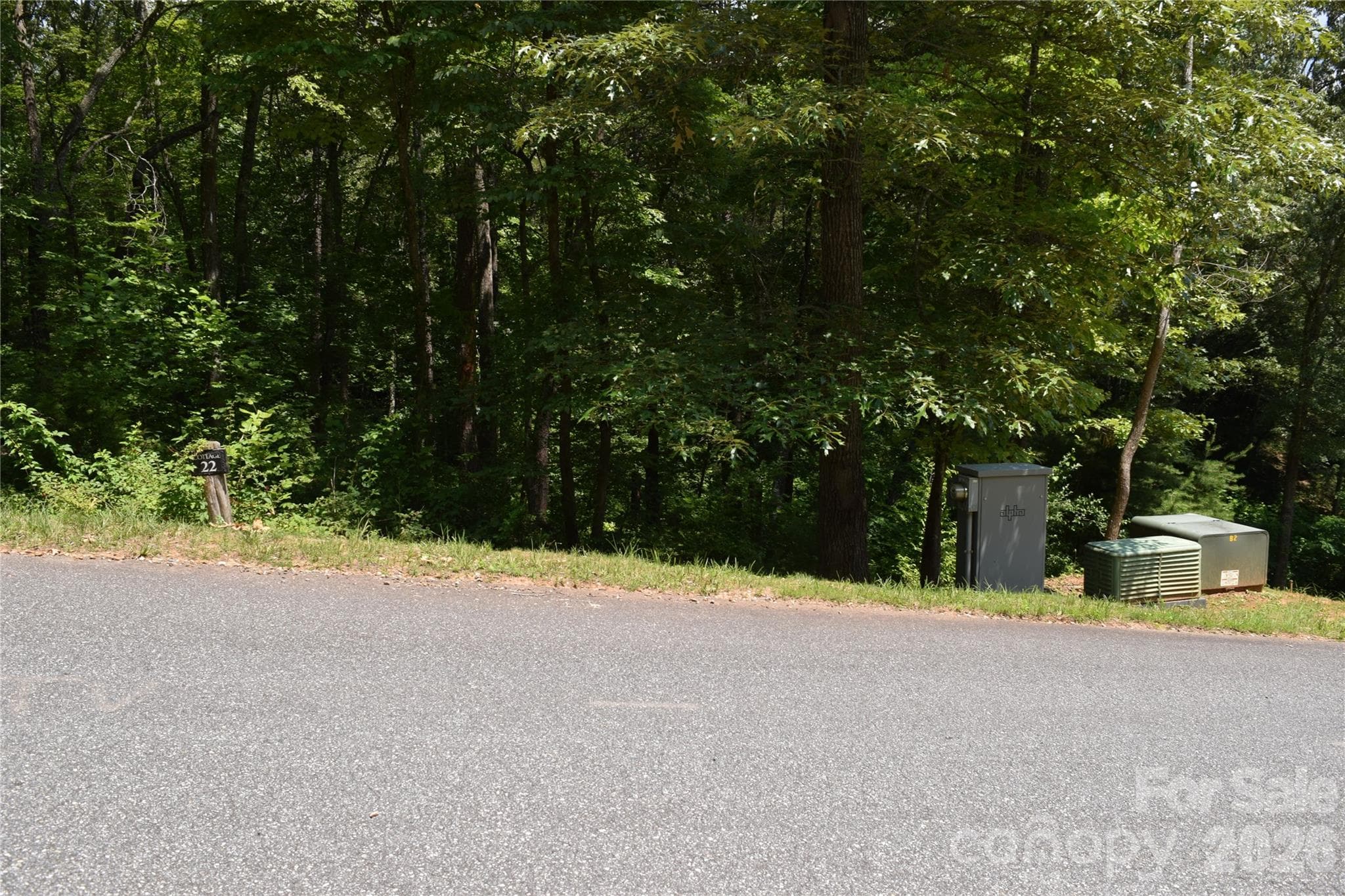 Lot 22 in June 2026 - utilites at corner of lot - 22 River Club Drive, Cullowhee