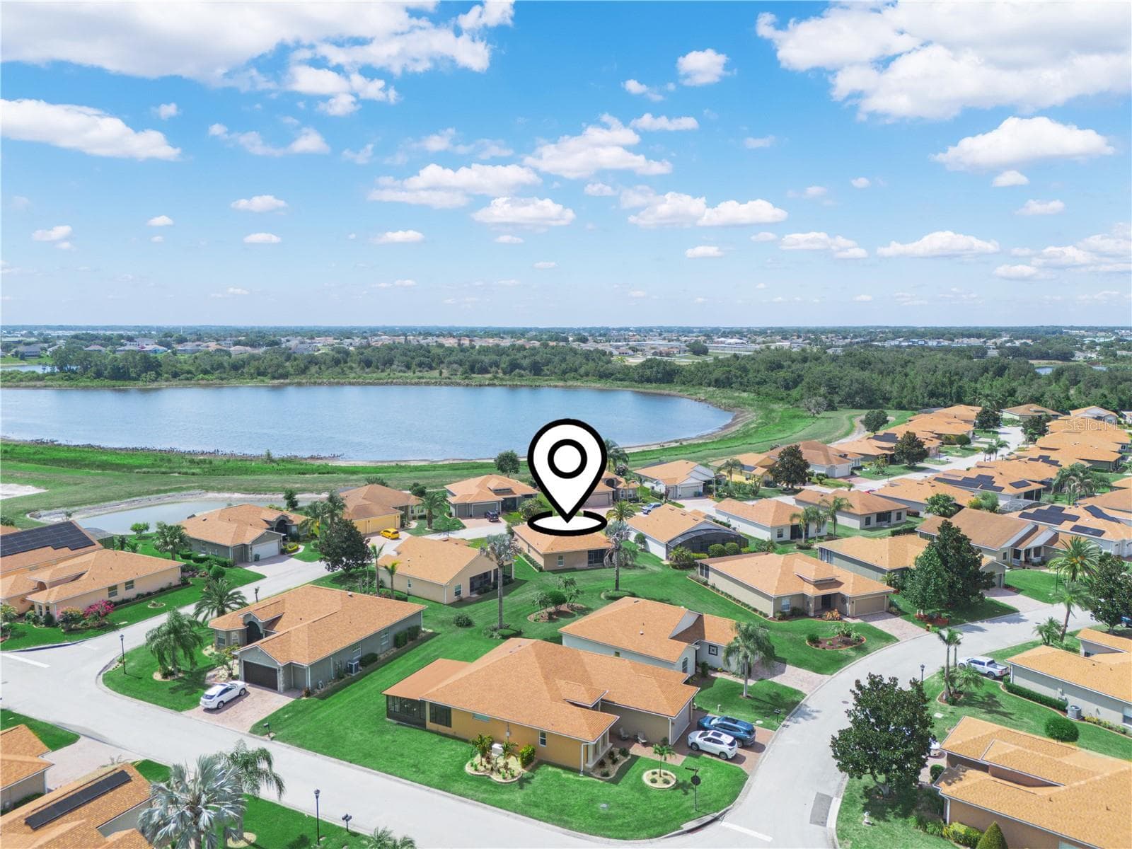 Aerial view of this community complete with golf courses and the beautiful lake. - 5308 GREEN DR, WINTER HAVEN