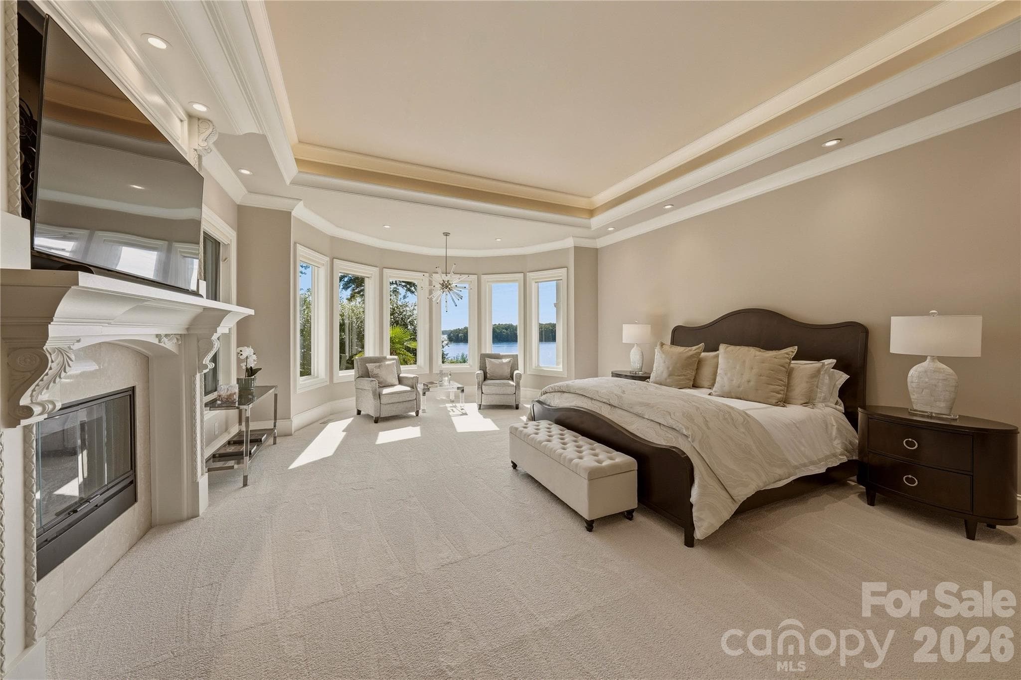 Main-level primary suite with panoramic lake views & a fireplace. - 16920 Harbor Master Cove, Cornelius
