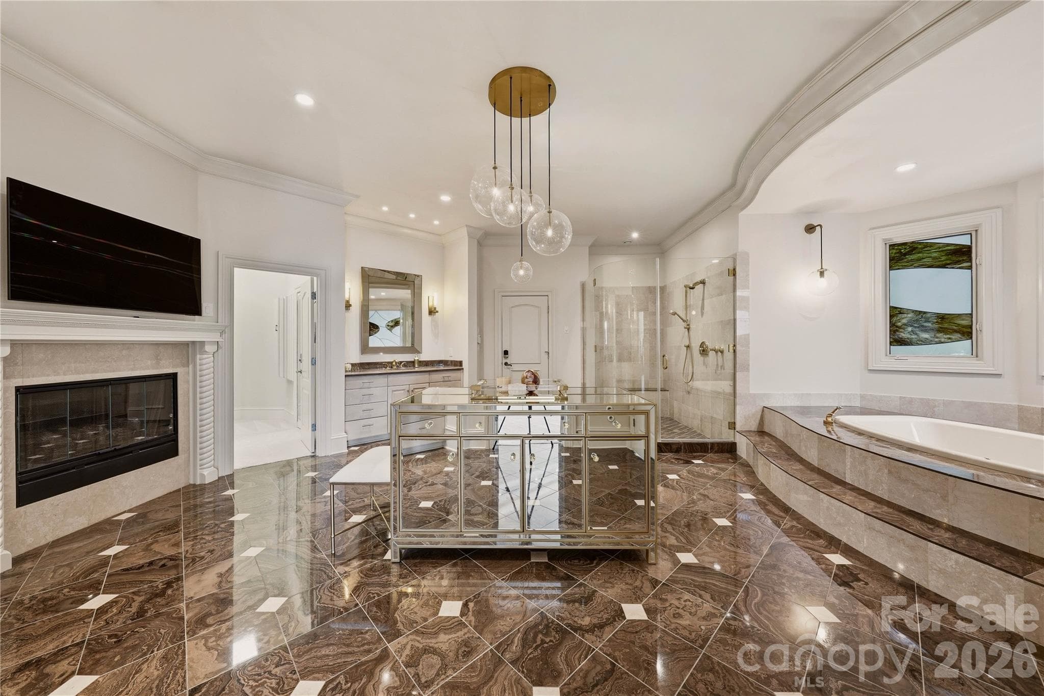 Main-level primary ensuite with two walk-in closets and access to the owner's garage. - 16920 Harbor Master Cove, Cornelius