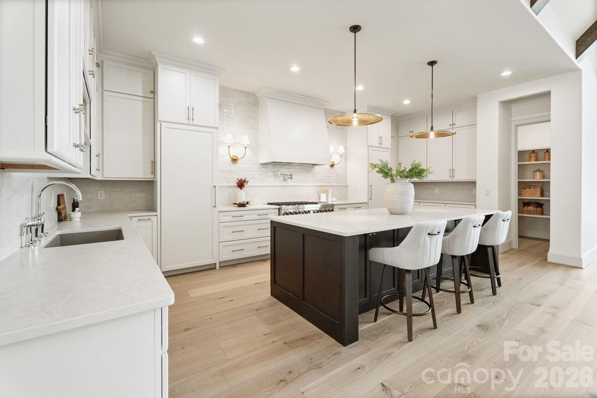 Gourmet kitchen highlighted by quartz counters, spacious island, and huge walk-in pantry - Denver
