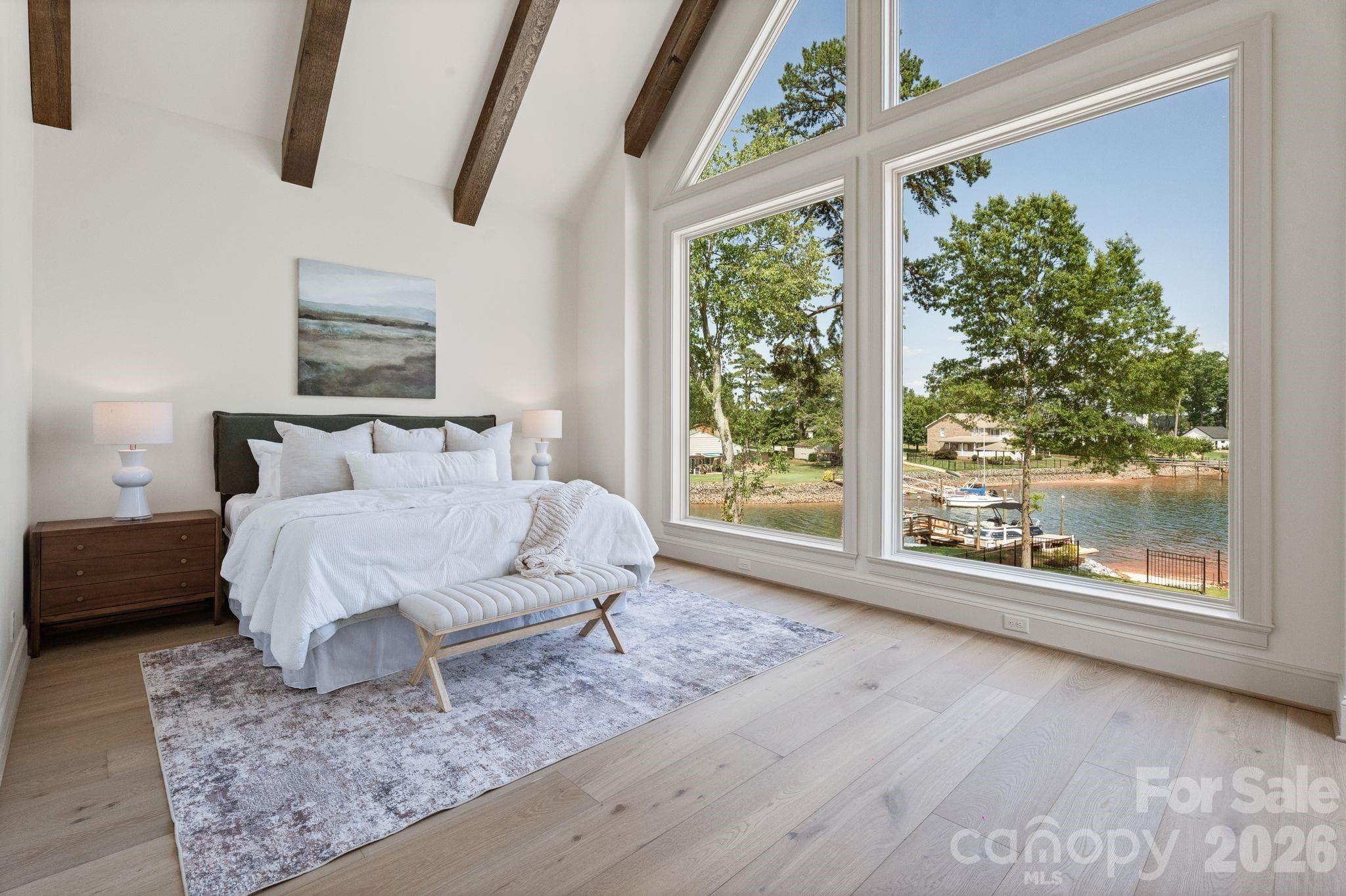 The wall of windows brighten the main level primary bedroom - 2494 Primm Road, Denver
