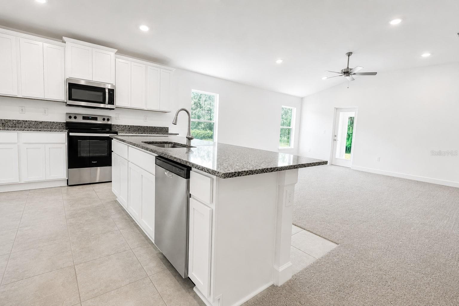 Kitchen Island and Open Living Area - 7606 BENT TREE LOOP, ST CLOUD