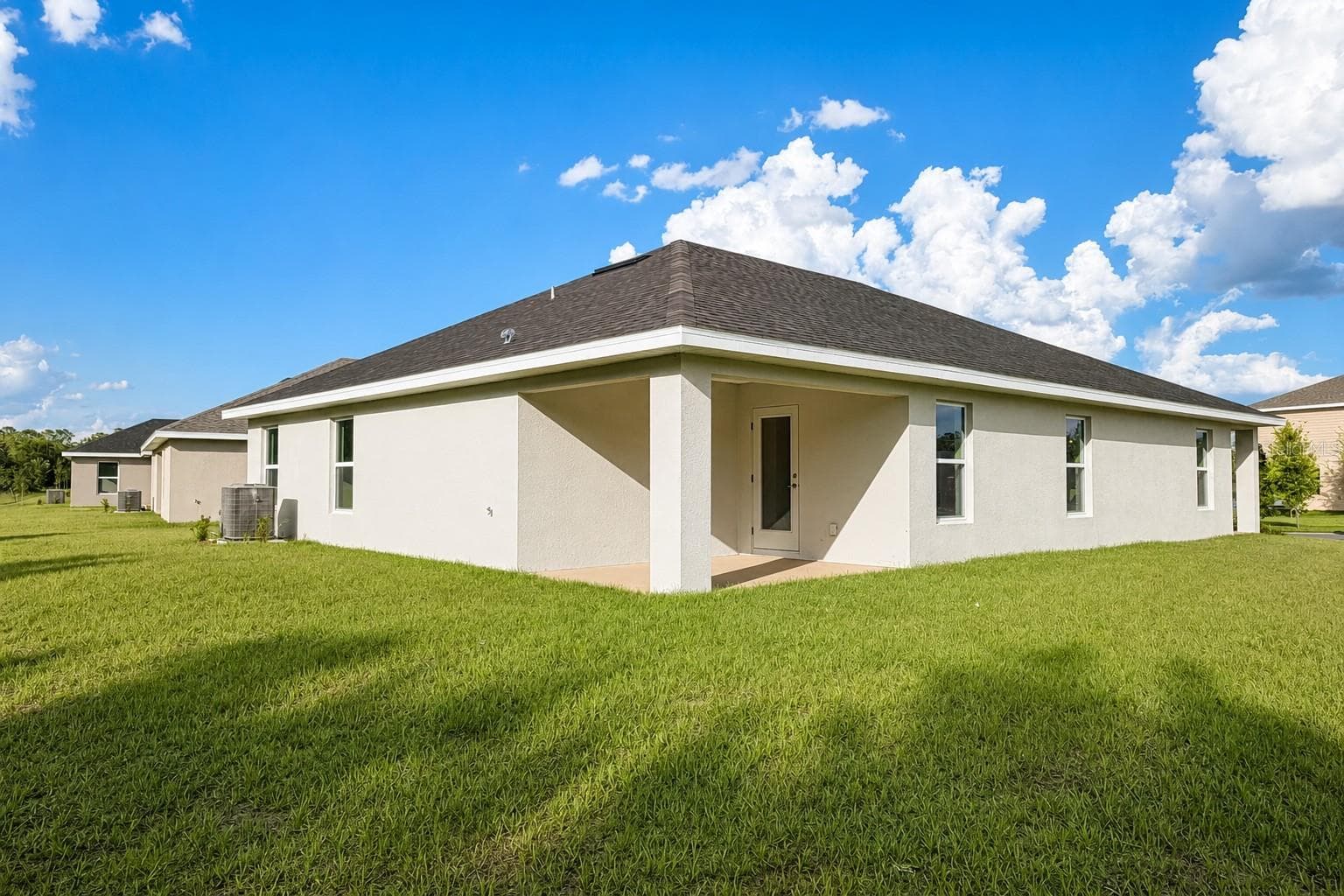Rear Exterior and Covered Patio - 7606 BENT TREE LOOP, ST CLOUD