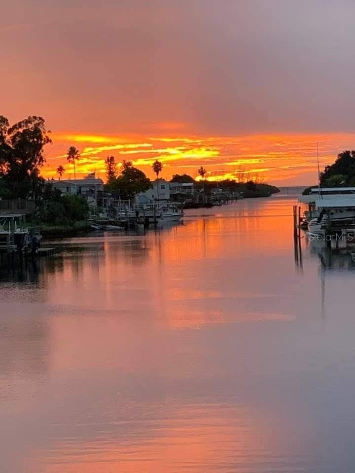 A sunset view down one of the canals. - 6629 TOWER DR, HUDSON