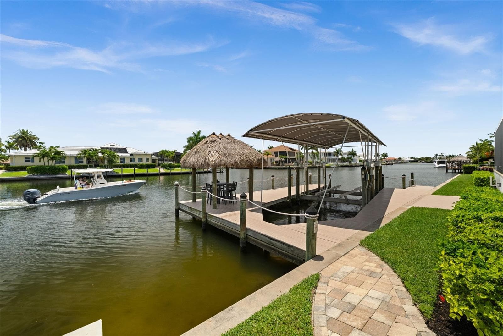 Dock with tiki and 30,000 lb covered boat lift - 105 SW 52ND ST, CAPE CORAL