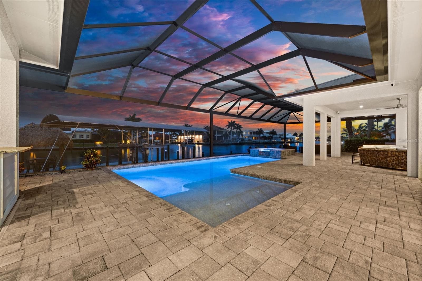 Great evening views of the pool and canal - 105 SW 52ND ST, CAPE CORAL