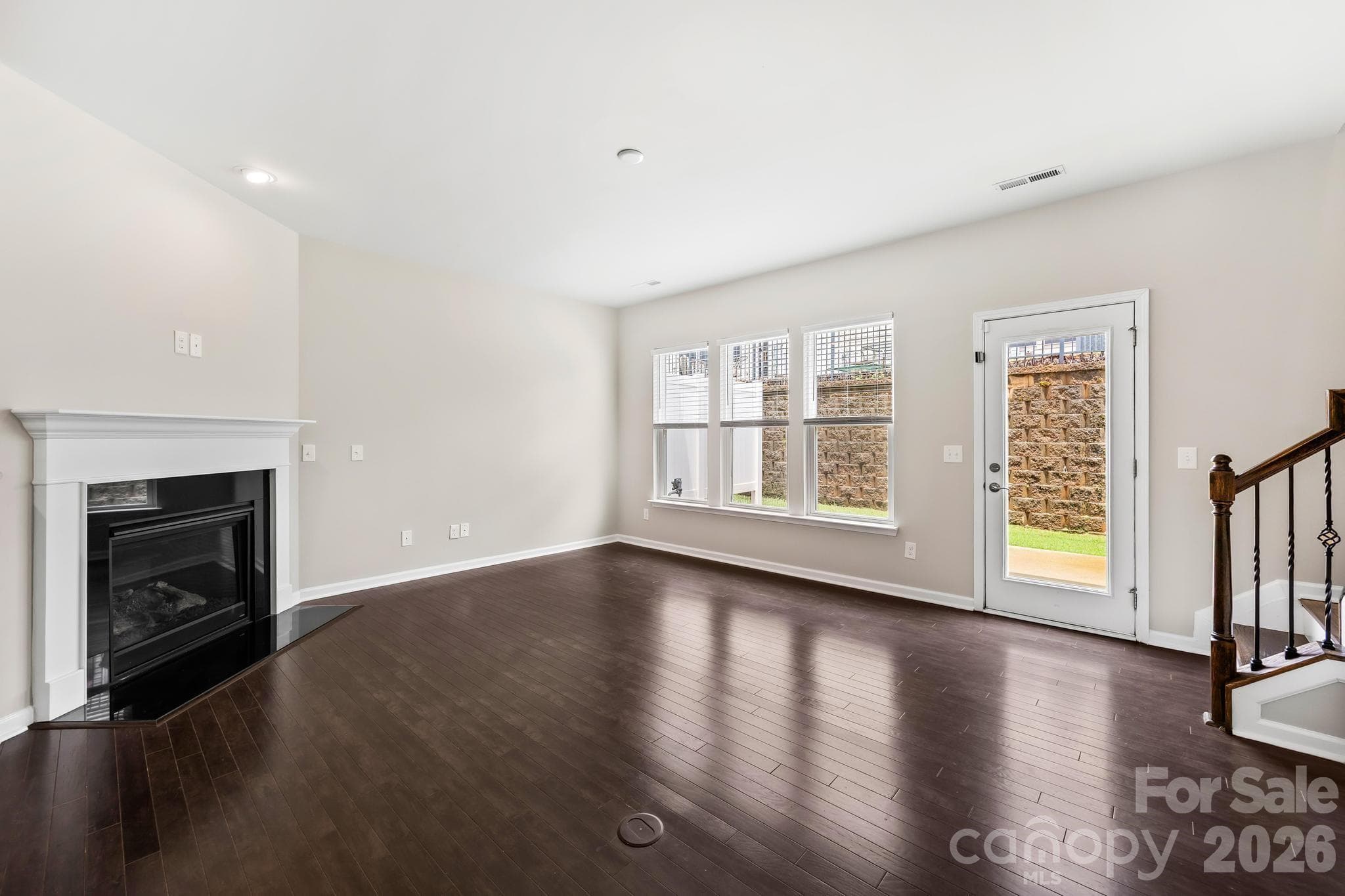 Gather around the cozy gas fireplace, creating a warm and inviting focal point for relaxing evenings at home. - Charlotte