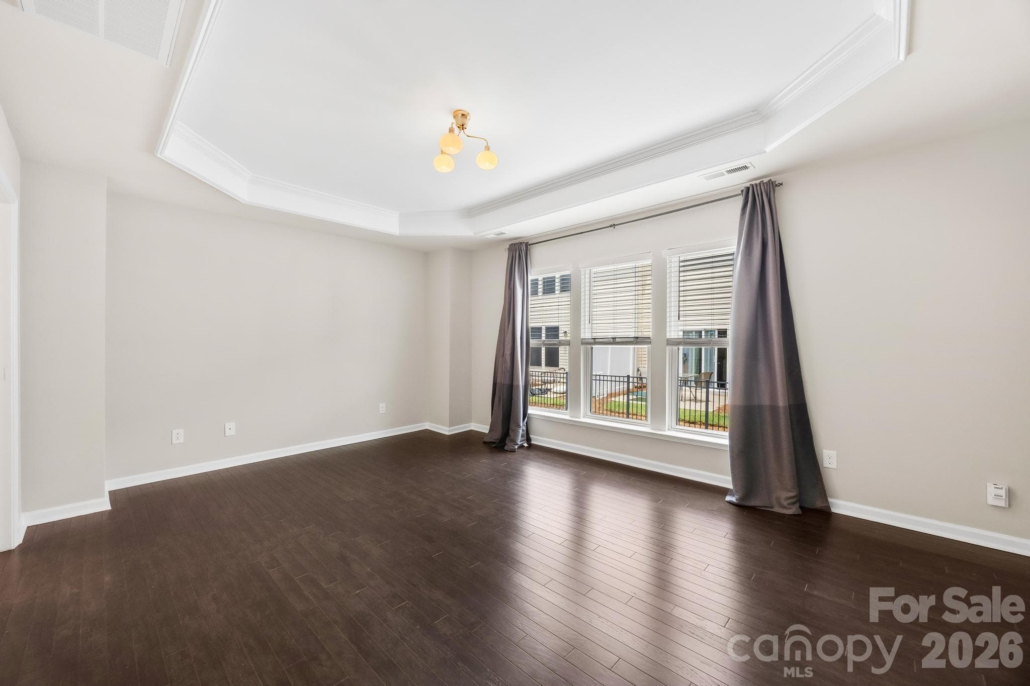 The generously sized primary suite offers a peaceful escape with abundant natural light and a relaxing atmosphere. - Charlotte