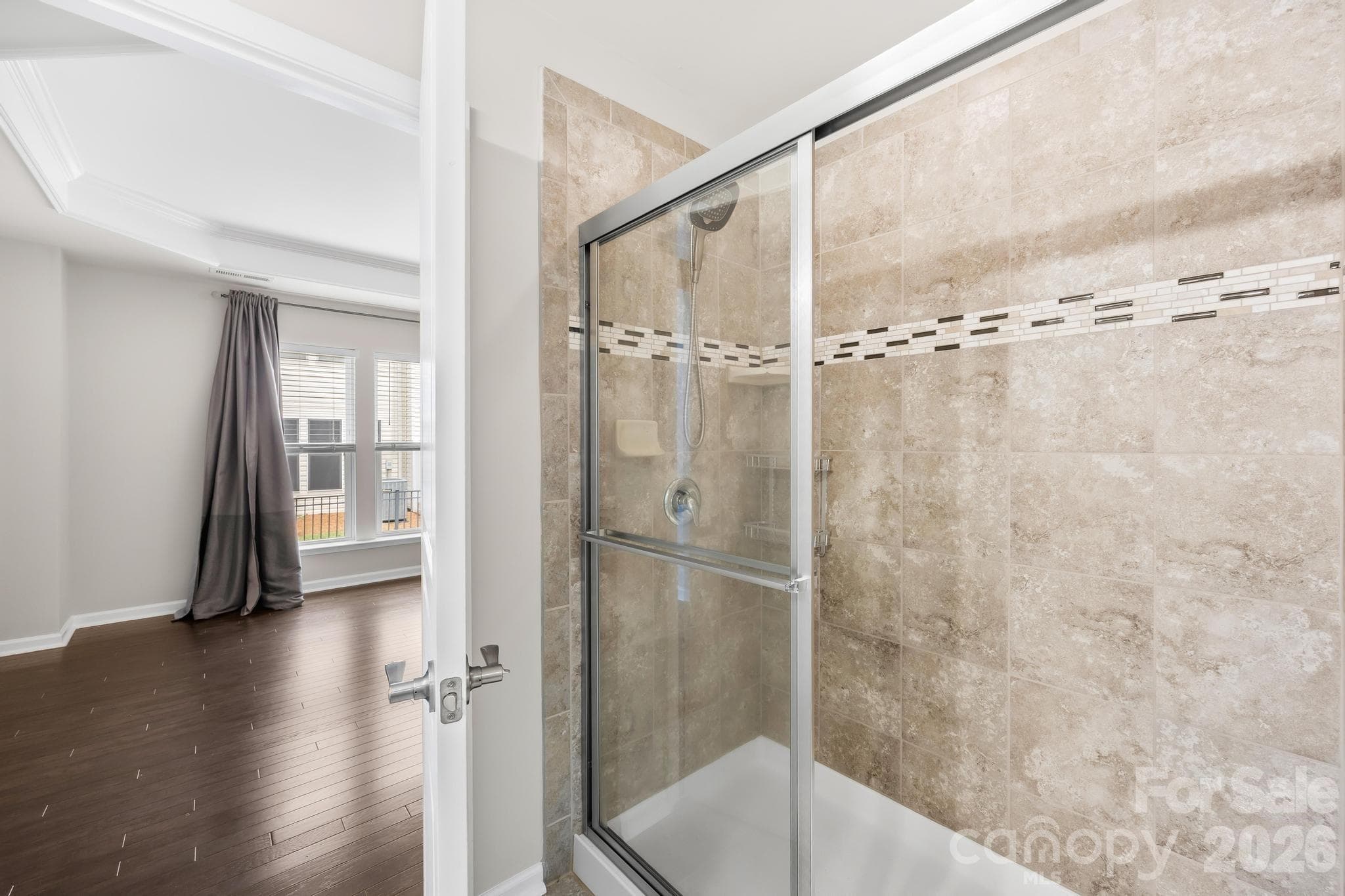 Tiled shower offers a retreat in the primary bathroom. - Charlotte