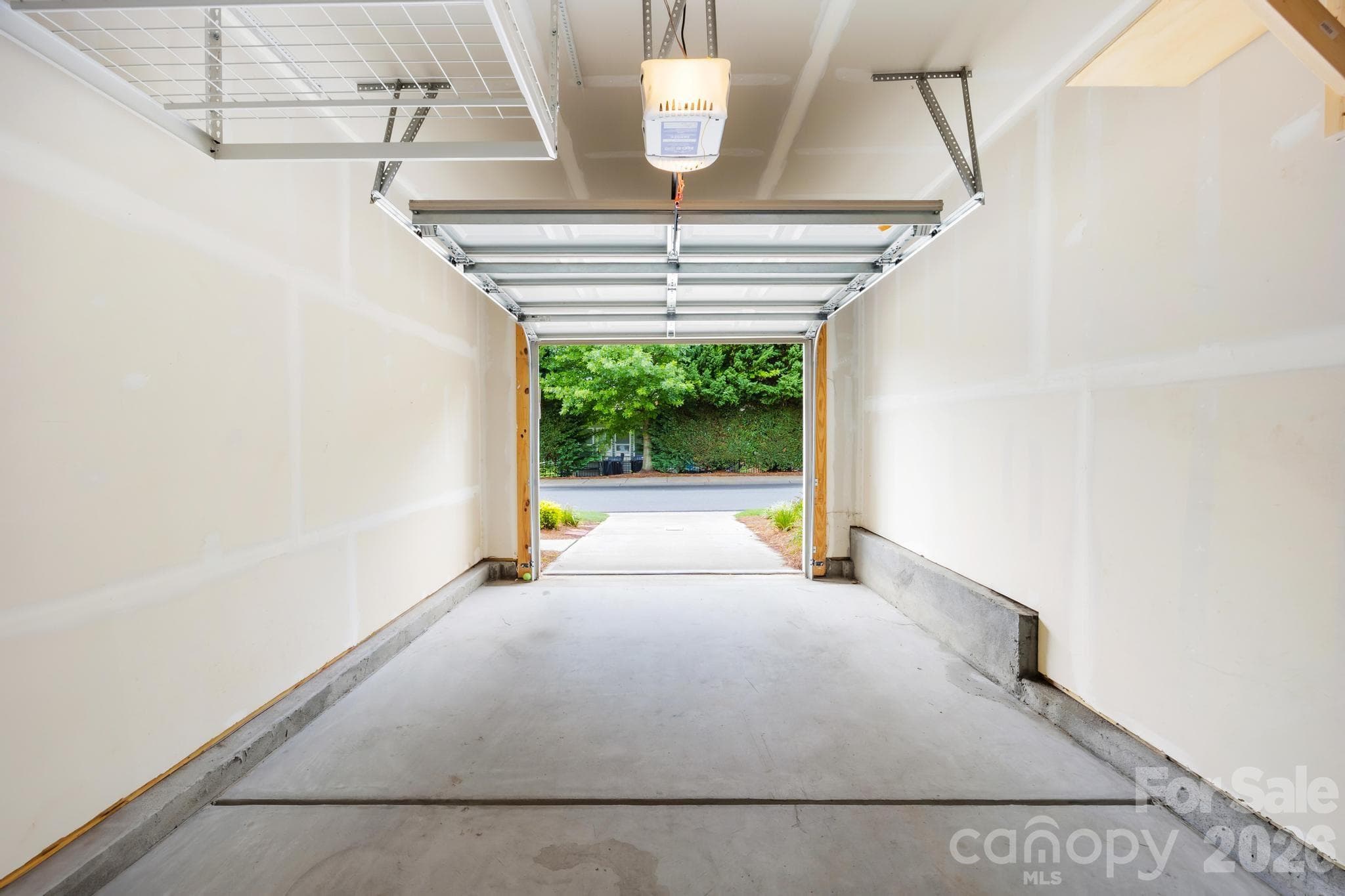 The attached garage provides secure parking along with additional storage space. - Charlotte