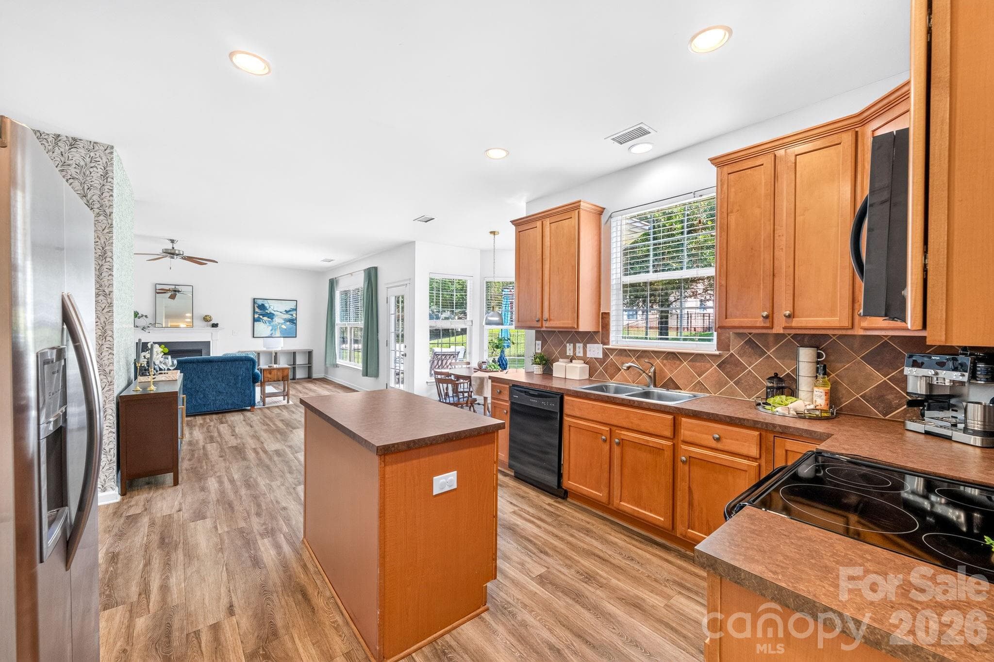 Kitchen. Spacious kitchen with ample cabinetry, generous counter space, and center island. - Charlotte